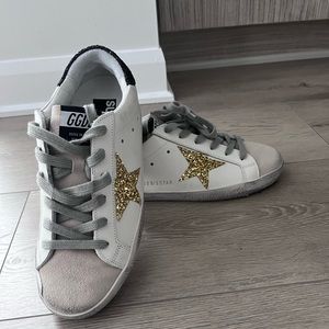 Golden Goose Super-Star sneakers with gold star and glittery black heel tab